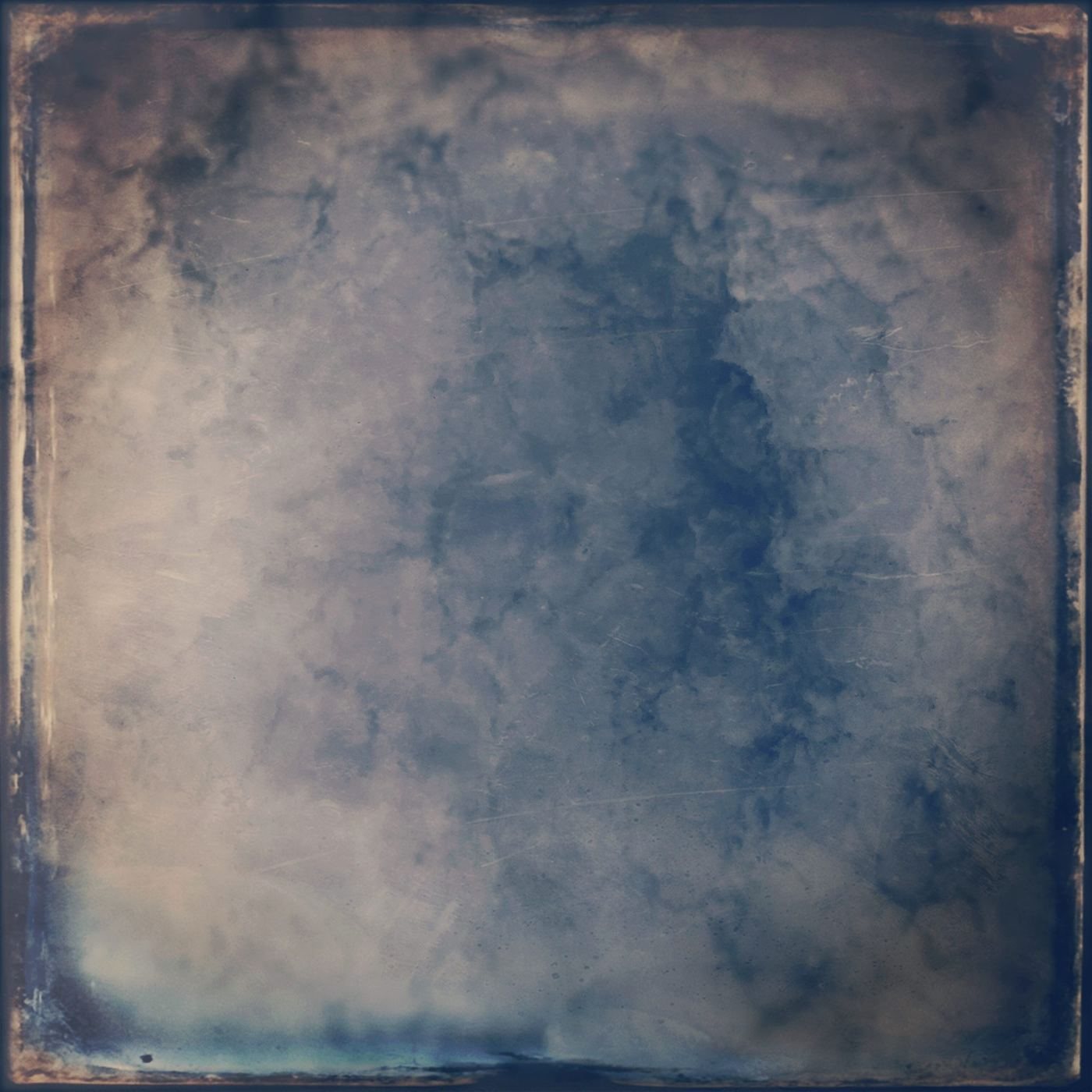 A worn, tinted surface of blue and sand, like clouds